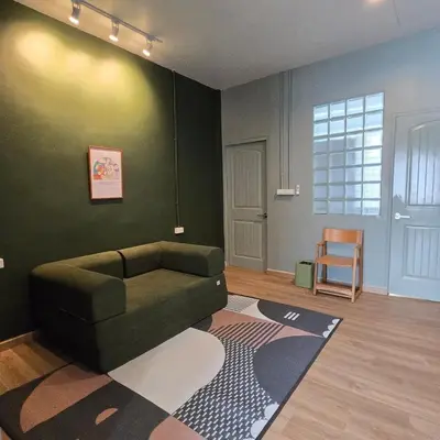 a living room with a green couch and a rug at Obahomu Vacation House for 4-8 pax, 5 min walk to Icon Siam in Bangkok