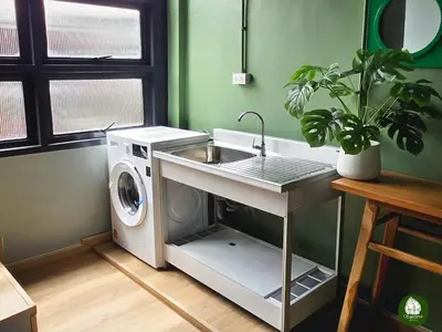 a kitchen with a sink and a washing machine at Obahomu Vacation House for 4-8 pax, 5 min walk to Icon Siam in Bangkok