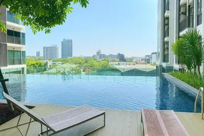 a swimming pool in the middle of a building at Peaceful Stylish and cozy condo in Khlong Toei
