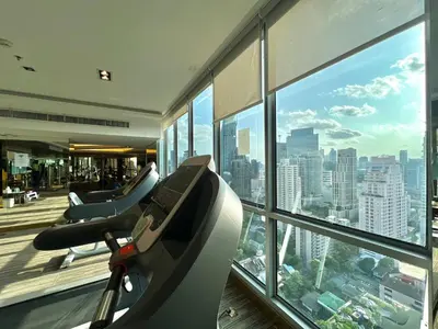 an office with a gym with a view of the city at 5min Metro | KingBed | Kitchen full | Netflix WiFi in Khlong Toei