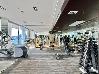 a gym with cardio equipment in a building at 5min Metro | KingBed | Kitchen full | Netflix WiFi in Khlong Toei
