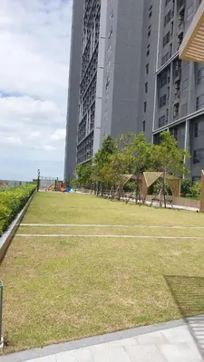 a park in a city with tall buildings at The Politan Aqua, River Front in Ban Sai Ma