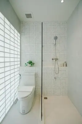 a bathroom with a toilet and a shower at I-Zen Residence Central Eastville in Bangkok