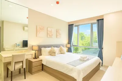 a bedroom with a bed and a desk and a window at 2 bed 2 bath luxury appartment Convention Center in Bangkok