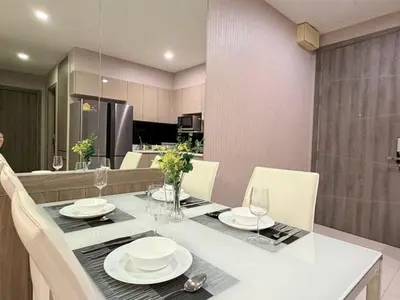 a dining room with a table with plates and glasses at 2 bed 2 bath luxury appartment Convention Center in Bangkok