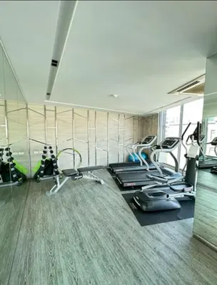 a gym with several treadmills and elliptical machines at 2 bed 2 bath luxury appartment Convention Center in Bangkok