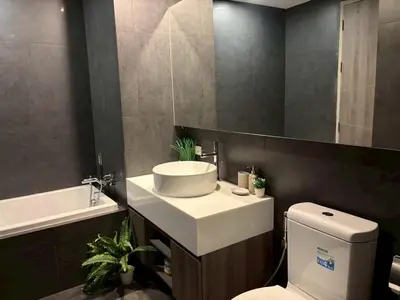 a bathroom with a sink and a toilet and a mirror at 2 bed 2 bath luxury appartment Convention Center in Bangkok