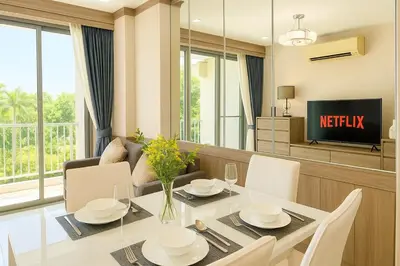 a dining room with a table and a tv at 2 bed 2 bath luxury appartment Convention Center in Bangkok