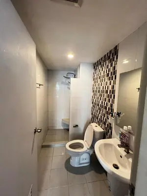 a bathroom with a toilet and a sink at คอนโดเดอะคิทท์พลัส 113 in Ban Khlong Samrong