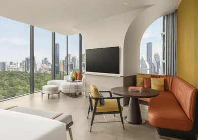 a living room with a view of a city at Andaz One Bangkok in Bangkok