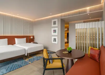a hotel room with a bed and a table at Andaz One Bangkok in Bangkok