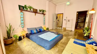a large blue bed in a room with plants at Baan YentaFo - Pink House in Talad Noi in Chinatown