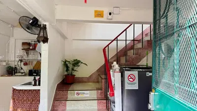 a kitchen with a staircase and a refrigerator in a room at Baan PadSeeEw - Rooftop Riverview in Khlong San