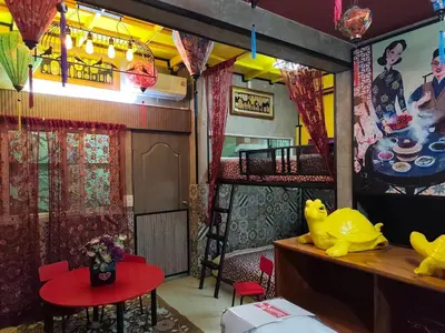 a room with a bunk bed and a room with a table at โรงแรม เลิฟ บีเคเค in Amphoe Phra Khanong