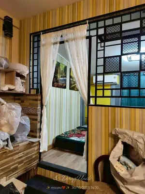 a small room with a bed and a window at โรงแรม เลิฟ บีเคเค in Amphoe Phra Khanong
