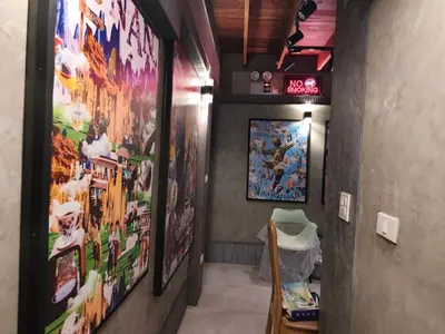 a hallway with pictures on the walls of a room at โรงแรม เลิฟ บีเคเค in Amphoe Phra Khanong
