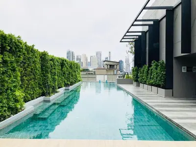 a swimming pool on the side of a building at Cozy room in Sukumvit in Bangkok