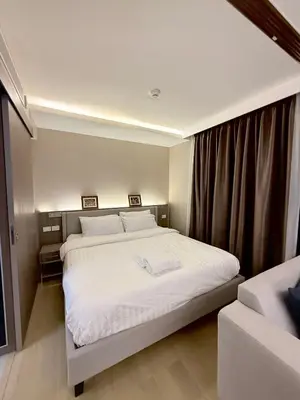 a bedroom with a large bed with white sheets at Cozy room in Sukumvit in Bangkok