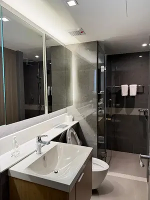 a bathroom with a sink and a toilet and a shower at Cozy room in Sukumvit in Bangkok