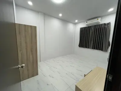 a room with a door and a tiled floor at Cozy Corner in Samut Prakan