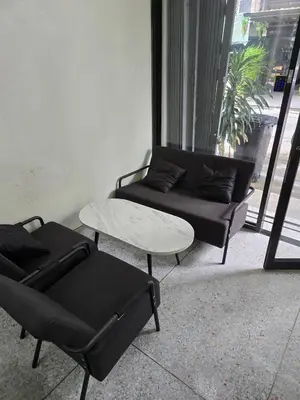 a living room with a couch and a table at Cozy bangkok hostel in Bangkok