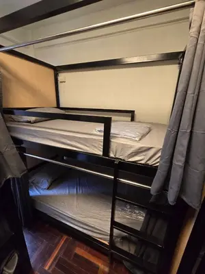 an empty bunk bed with a ladder on it at Cozy bangkok hostel in Bangkok