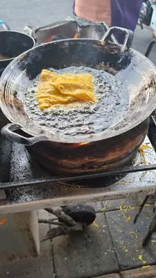 a frying pan with a piece of food in it at Old Town cozy corner in Thonhuri