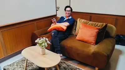 a woman sitting on a couch in a room at Old Town cozy corner in Thonhuri