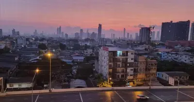 a city skyline at night with buildings and street lights at Old Town cozy corner in Thonhuri