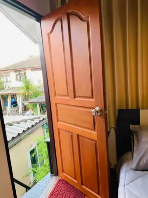 an open door to a balcony with a view at Palmhouse studio room in Bang Khen