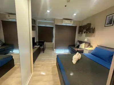 a living room with a blue bed and a couch at ห้องพัก แบบ Studio ติดเซ็นทรัลเวสเกต in Ban Bang Krabu