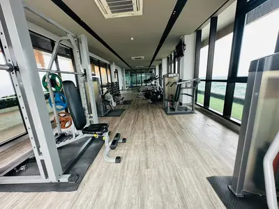 a gym with treadmills and machines in a building at ห้องพัก แบบ Studio ติดเซ็นทรัลเวสเกต in Ban Bang Krabu