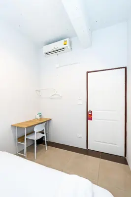 a white room with a desk and a white door at XX The Hidden Khaosan Road Bangkok in Bang Bua Thong Railway Station