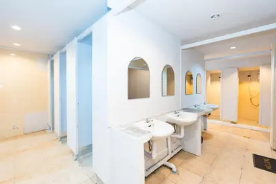 a bathroom with two sinks and two mirrors at XX The Hidden Khaosan Road Bangkok in Bang Bua Thong Railway Station