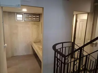 a room with a staircase and a door with a window at XX GO INN Silom - BTS Surasak in Yan Nawa