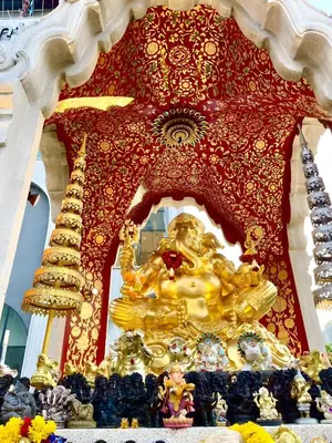 a gold statue of a lion in a shrine at XX GO INN Silom - BTS Surasak in Yan Nawa
