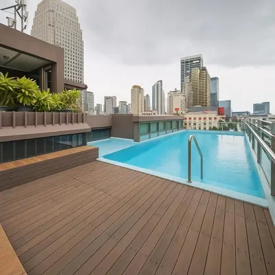 a rooftop swimming pool on the roof of a building at Executive 1 BR and Sofa bed Next to T21 Asoke BTS in Bangkok