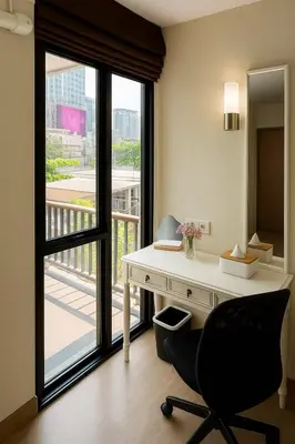 an office with a desk and a chair and a window at Executive 1 BR and Sofa bed Next to T21 Asoke BTS in Bangkok