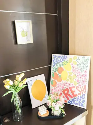 a table with a vase of flowers and some pictures at Modern 2 Bed Executive Unit 5min to Nana BTS in Bangkok