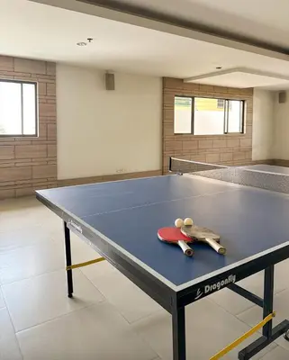 a ping pong table with two ping pong tools on it at Nana SkyView Retreat 2 Bedroom 2 Bath Nana BTS in Bangkok