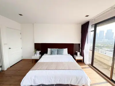 a bedroom with a large bed and a large window at Nana SkyView Retreat 2 Bedroom 2 Bath Nana BTS in Bangkok