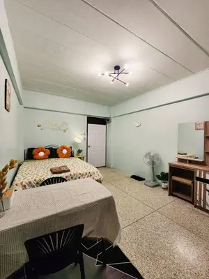 a bedroom with a bed and a table and a mirror at 704-STP Homely room Free Wi-Fi and Near BTS in Bangkok