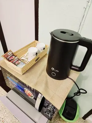 a coffee maker sitting on top of a table at 704-STP Homely room Free Wi-Fi and Near BTS in Bangkok
