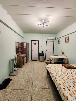a bedroom with a bed and a table and a ceiling at 704-STP Homely room Free Wi-Fi and Near BTS in Bangkok