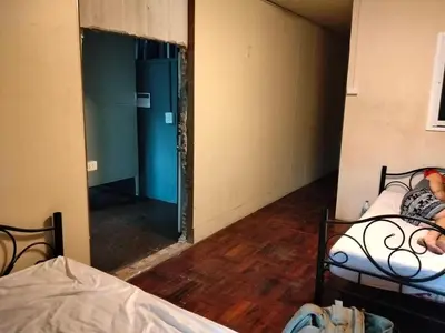 a room with two beds and a mirror at A fantastic house next to W district food market in Amphoe Phra Khanong