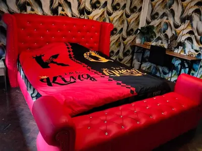 a red couch with a bed in a room at A fantastic house next to W district food market in Amphoe Phra Khanong