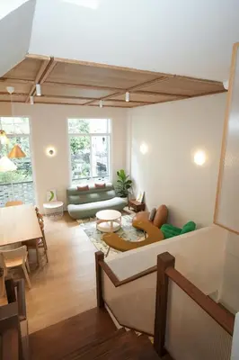 a living room with a couch and a table at day one space - BTS On Nut - Live Above Cowork Cafe in Bangkok
