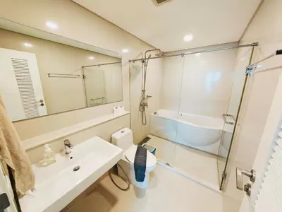 a bathroom with a sink and a toilet and a mirror at Downtown, Cozy 1BR, 48sqm, Middle of ThongLo, High Floor, Pool, Gym, Fast Wifi in Bangkok