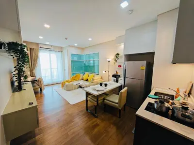 a kitchen and living room with a table and a couch at Downtown, Cozy 1BR, 48sqm, Middle of ThongLo, High Floor, Pool, Gym, Fast Wifi in Bangkok
