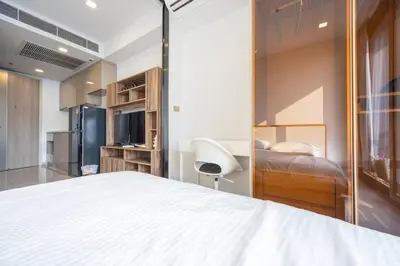 a bedroom with a bed and a desk and a chair at 49floor with Workspace Pool and Gym with MRT 200m in Bangkok